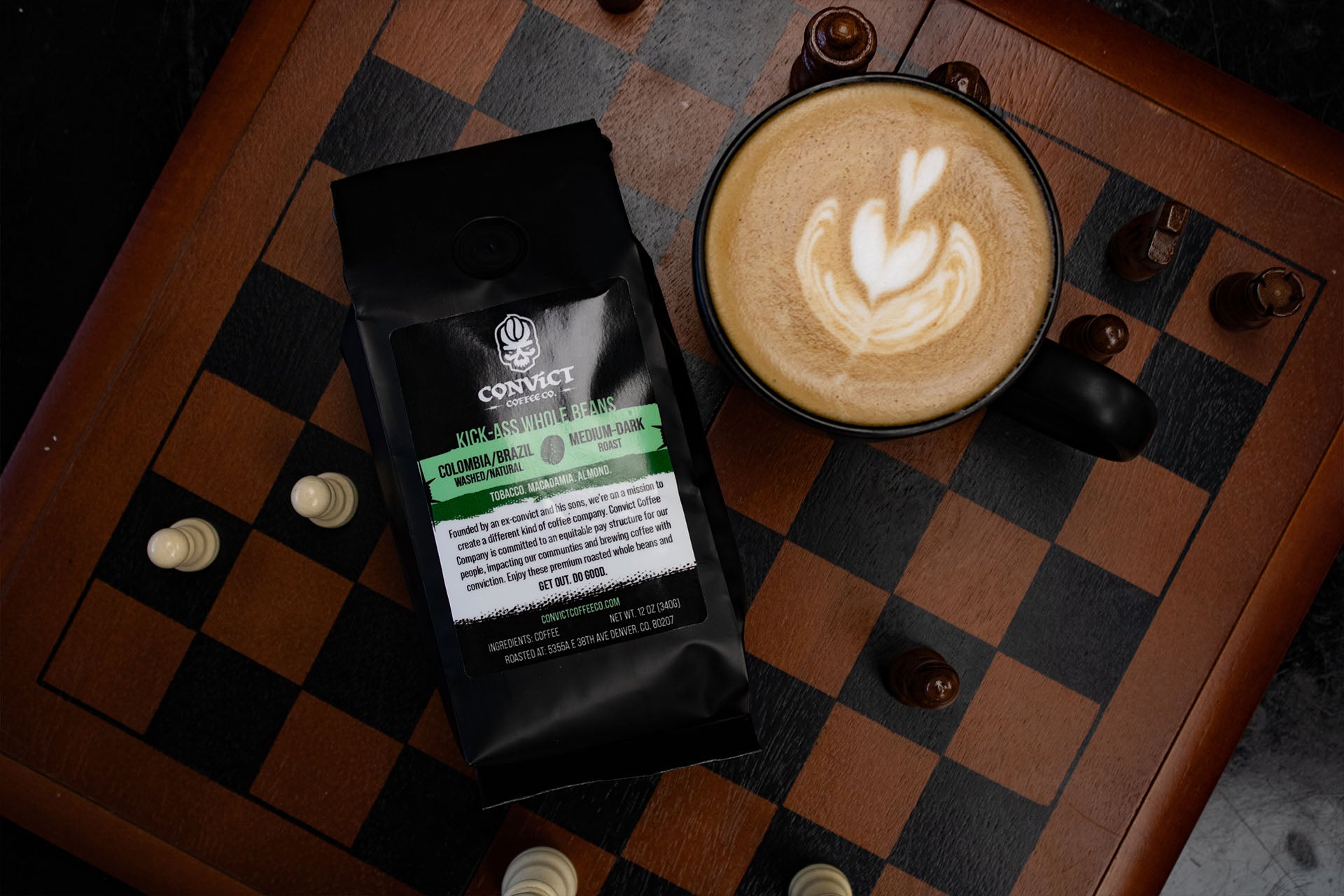 Coffee bag and latte in a black mug on a chess board with chess pieces