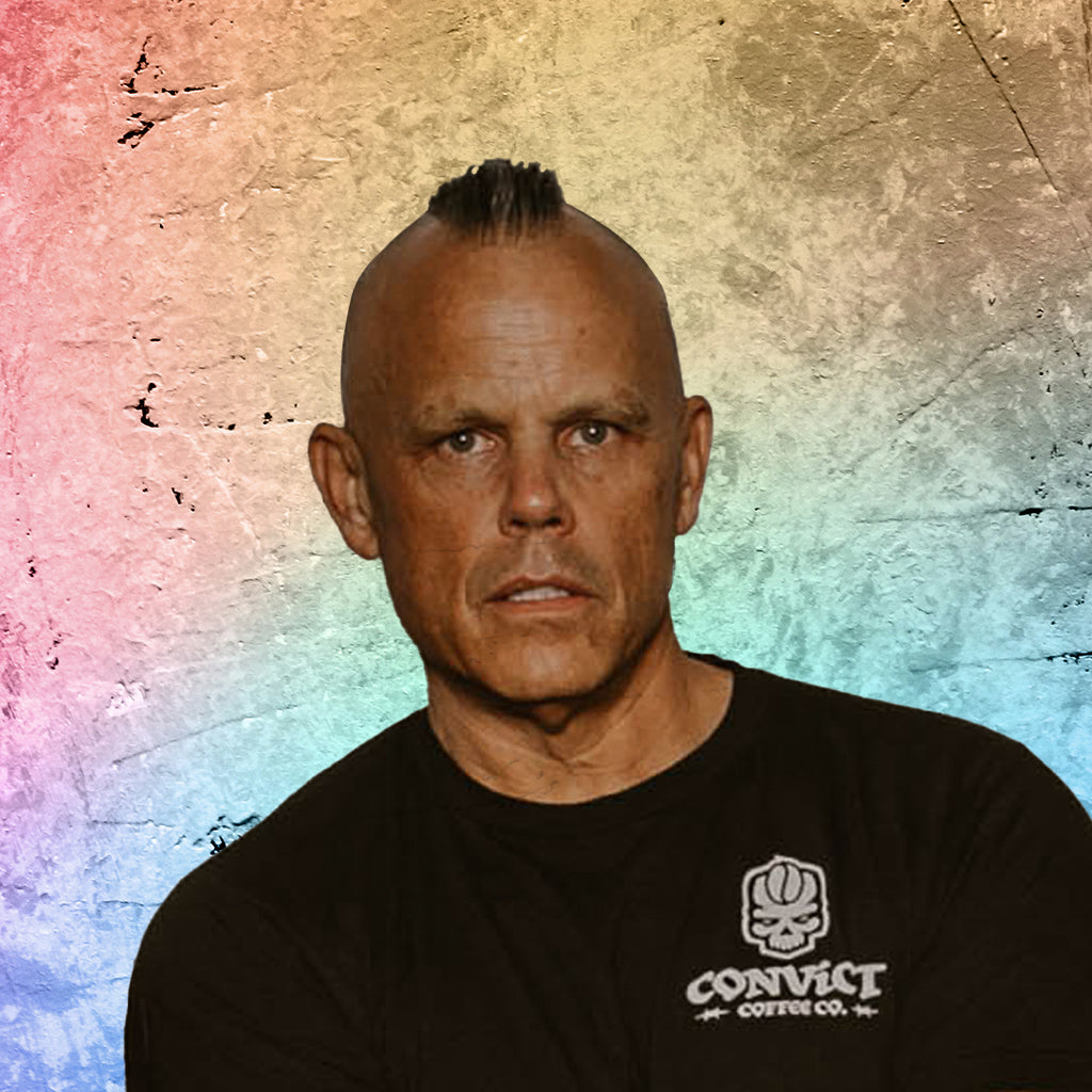 Dan Klehm wearing a black t-shirt with a logo on a textured multicolored background