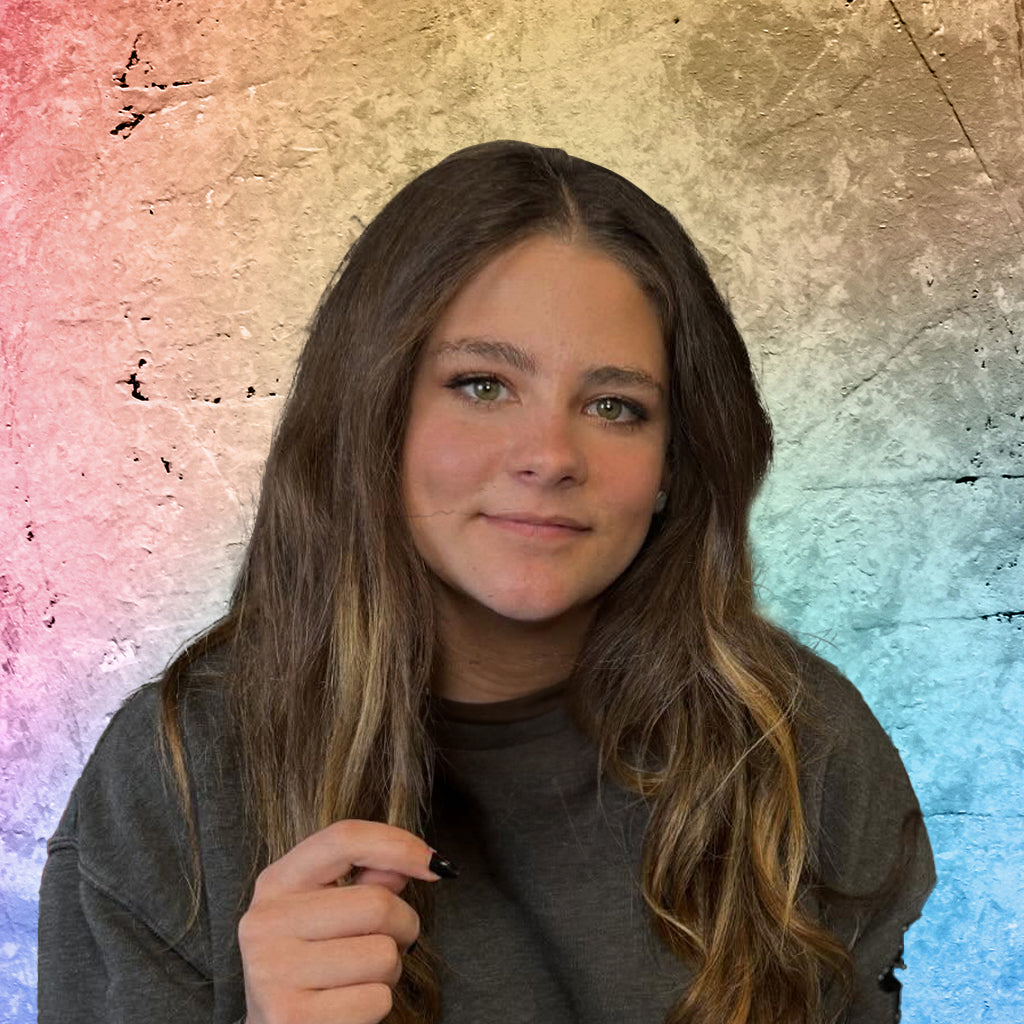 Jade Davis with long hair against a colorful, textured background
