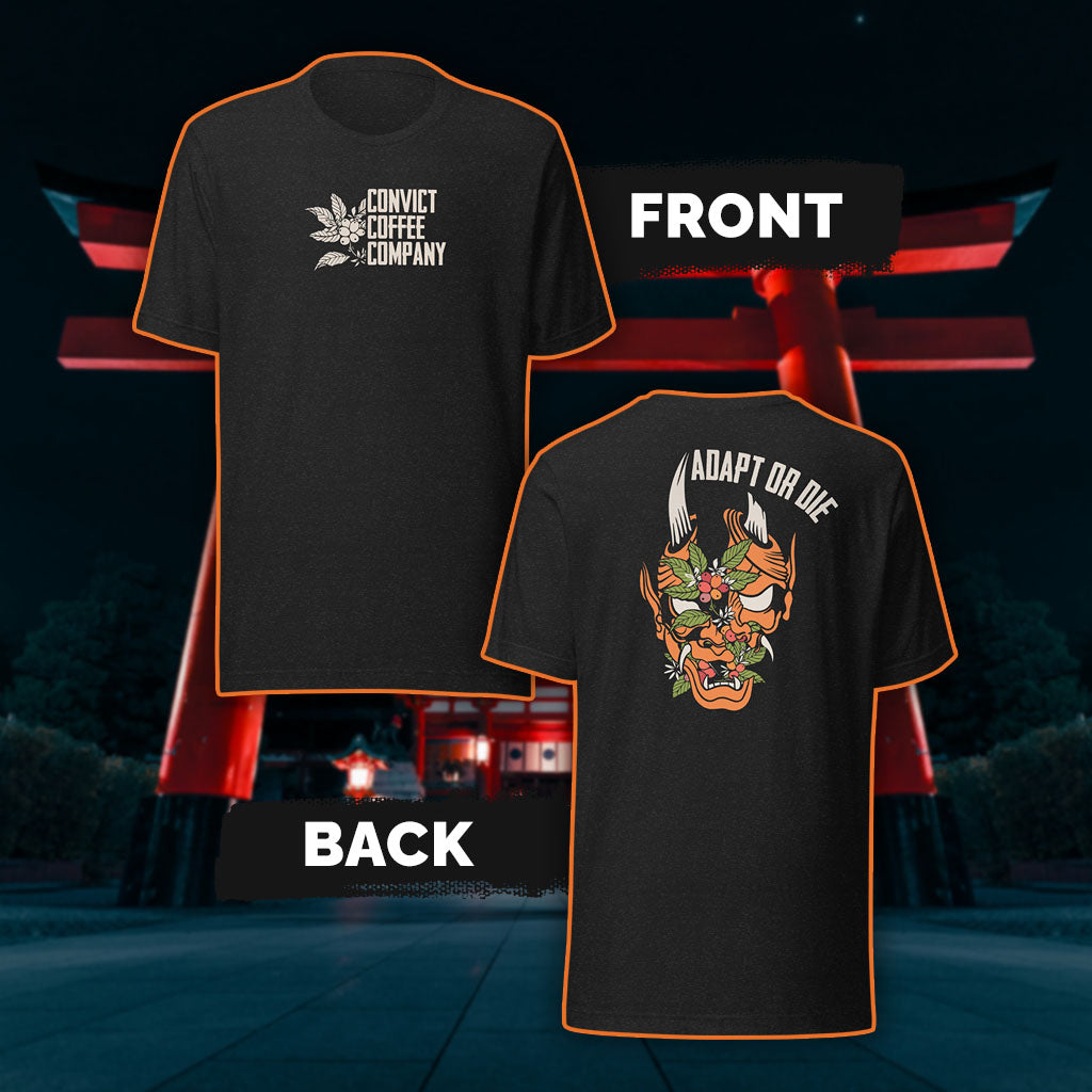 Black Heather tank top with a Japanese Oni and coffee plant design and 'Adapt or Die' text in front of red torii gates.
