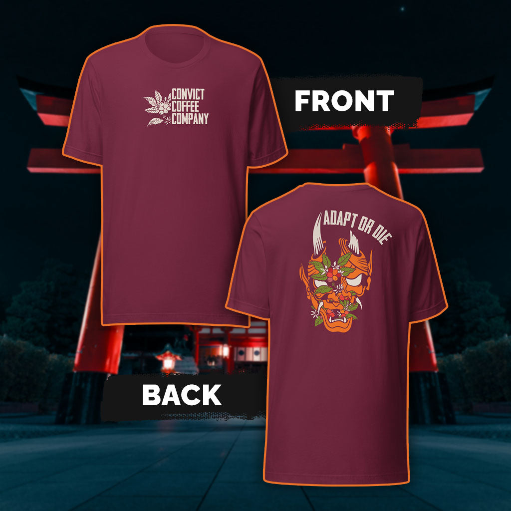 Maroon tank top with a Japanese Oni and coffee plant design and 'Adapt or Die' text in front of red torii gates.