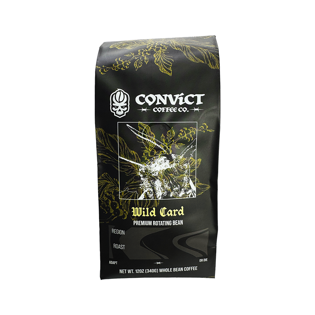 A 12 oz bag of Convict Coffee Co. Wild Card Premium Rotating Bean coffee, featuring a black bag with gold botanical illustrations and white text.