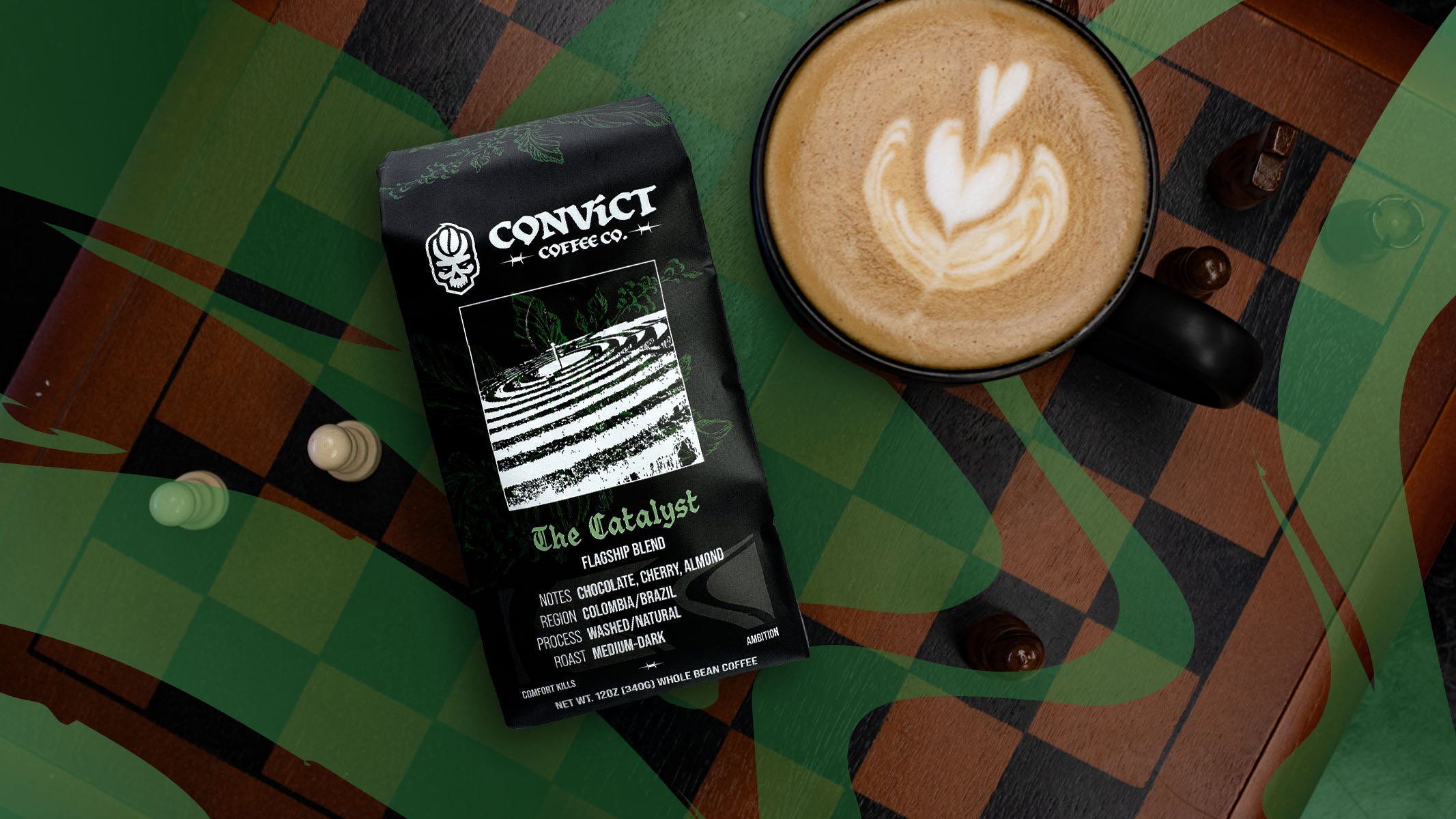 A bag of Convict Coffee Co. 'The Catalyst' flat roast coffee lies next to a black cup of latte art coffee on a chessboard