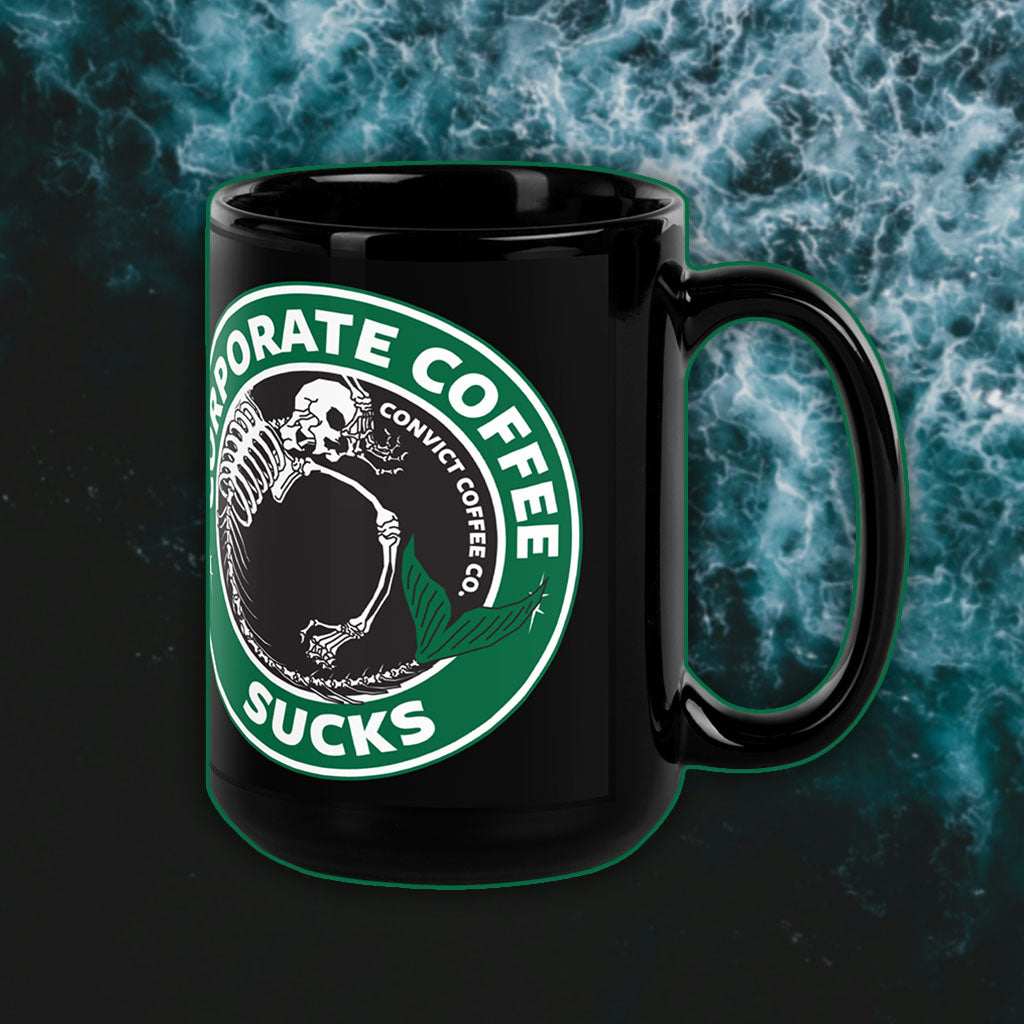 Black Mug with a Corporate Coffee Sucks Design on a dark, water background