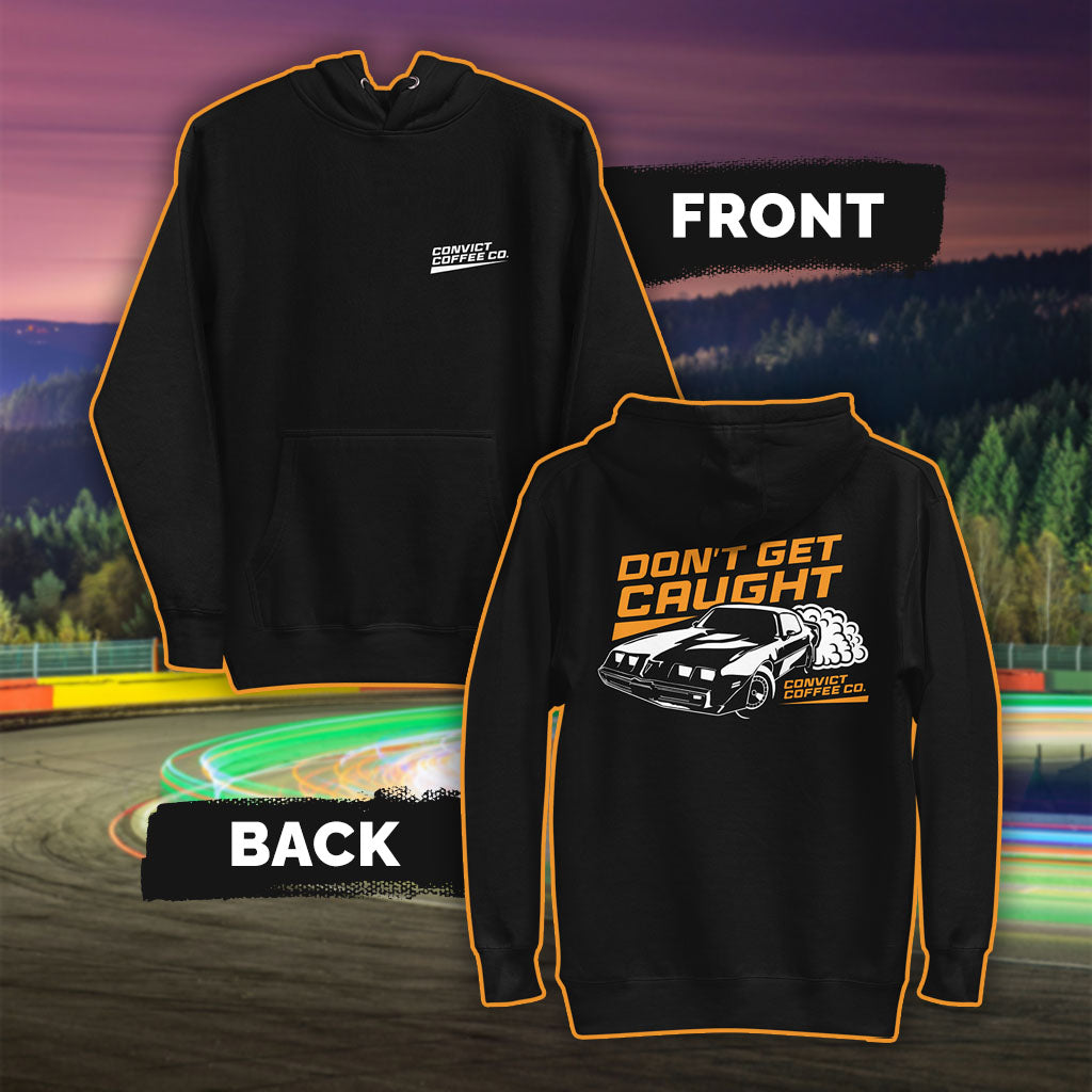 Black hoodie with Pontiac firebird 'Don't Get Caught' white and orange back print and 'Convict Coffee Co." words white left chest print set on a colorful race track background
