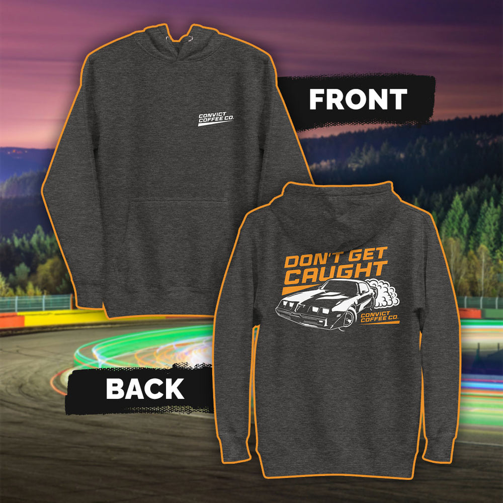 Charcoal Heather hoodie with Pontiac firebird 'Don't Get Caught' white and orange back print and 'Convict Coffee Co." words white left chest print set on a colorful race track background