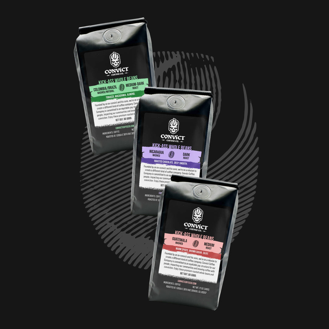 Three coffee packages from Convict Coffee on a black background
