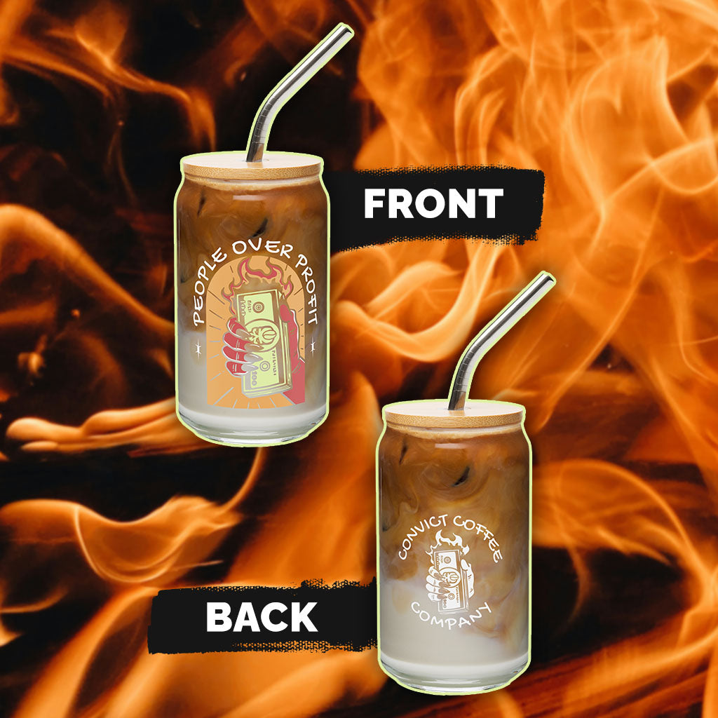 Two glass jars with metal straws on a fiery background, with 'people over profit' colorful hand holding burning money design on front and 'convict coffee company' white hand holding burning money on back