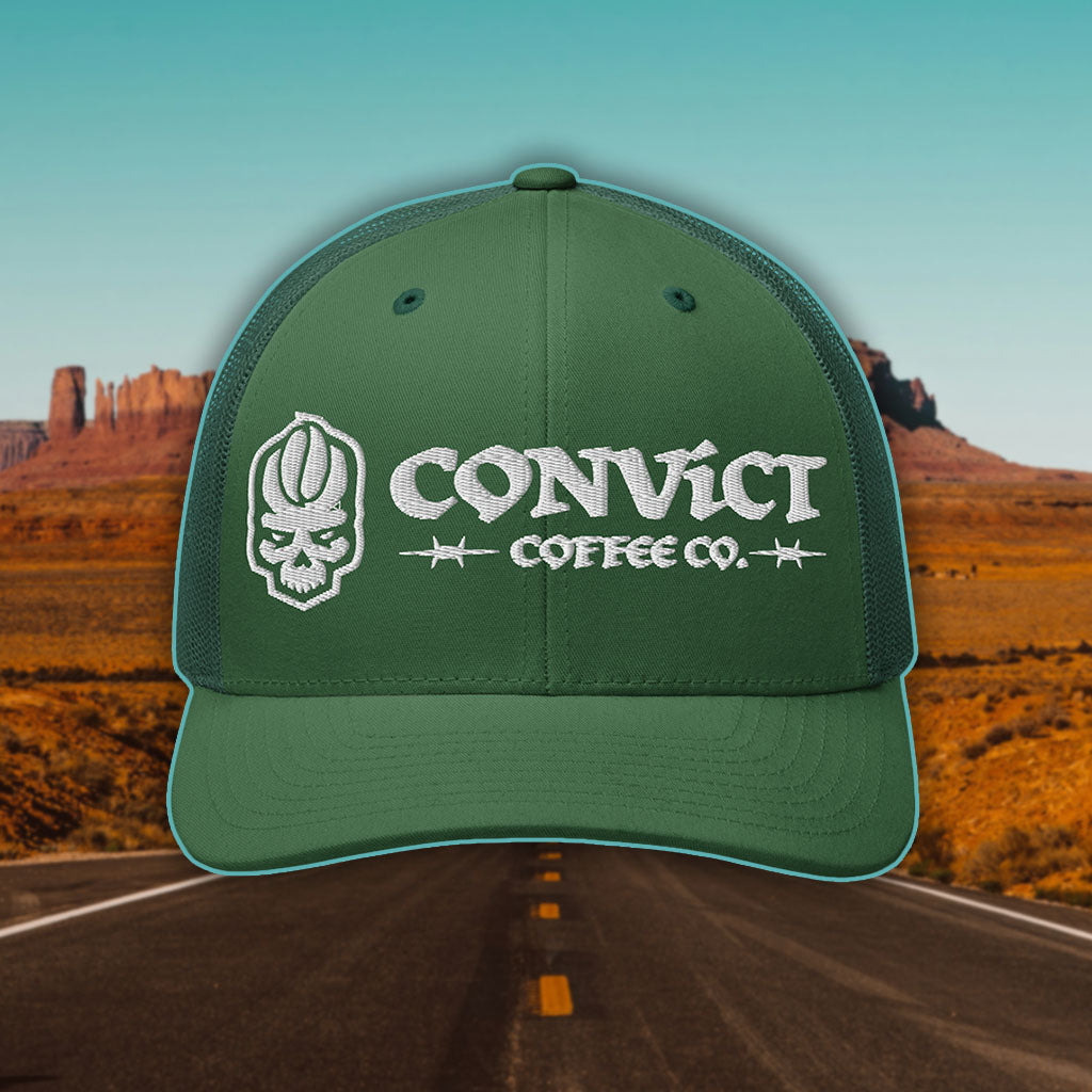 Evergreen Hat with 'Convict Coffee Co.' logo white embroidery on a Desert Road background